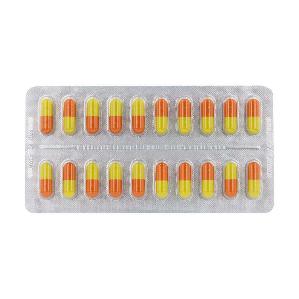 Plaquette thermoformée de gélules. Gélules bicolores jaune et orange, disposées dans un emballage argenté.