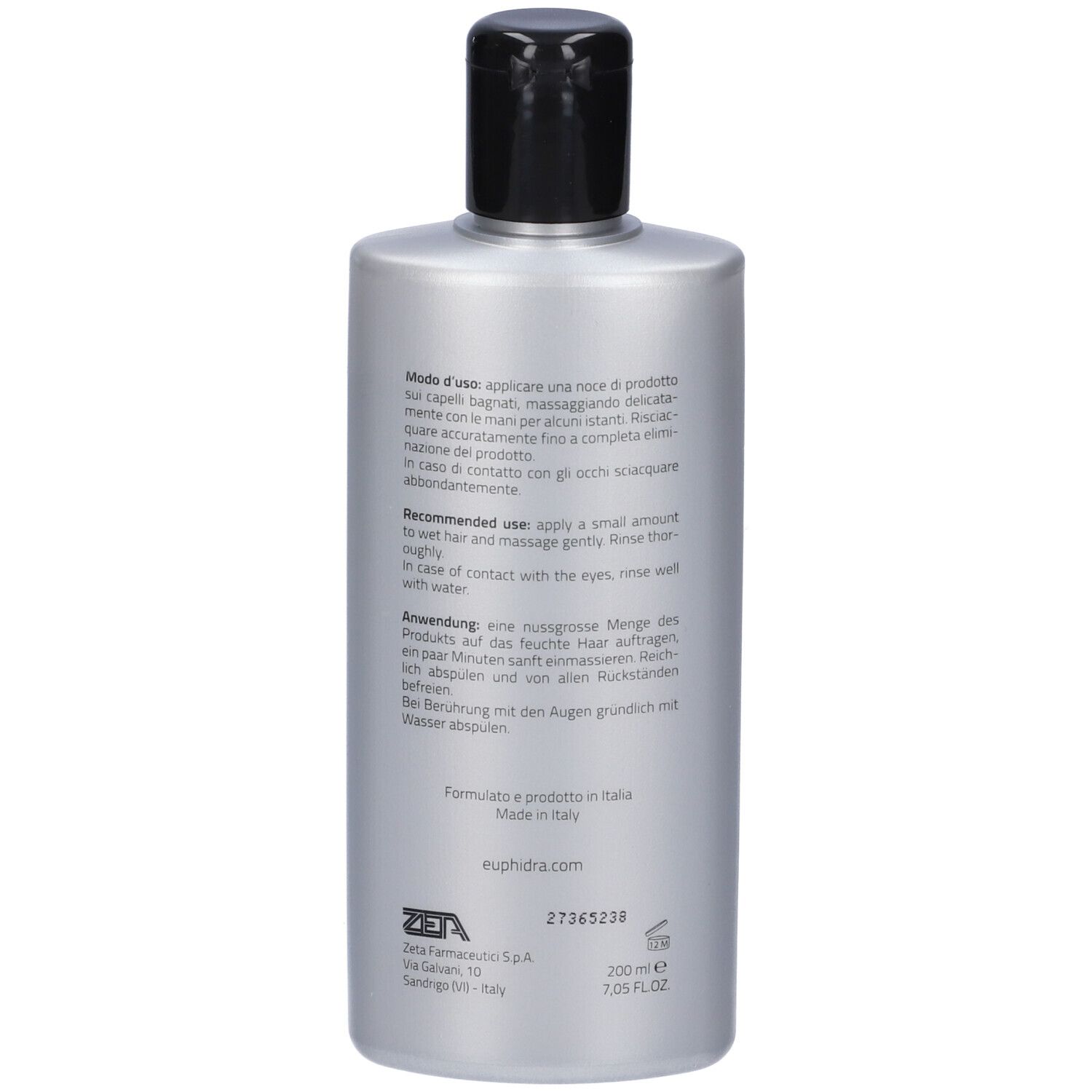 Dos d'un flacon de shampooing argenté. Texte multilingue. Contient des informations sur l'utilisation et les ingrédients.
