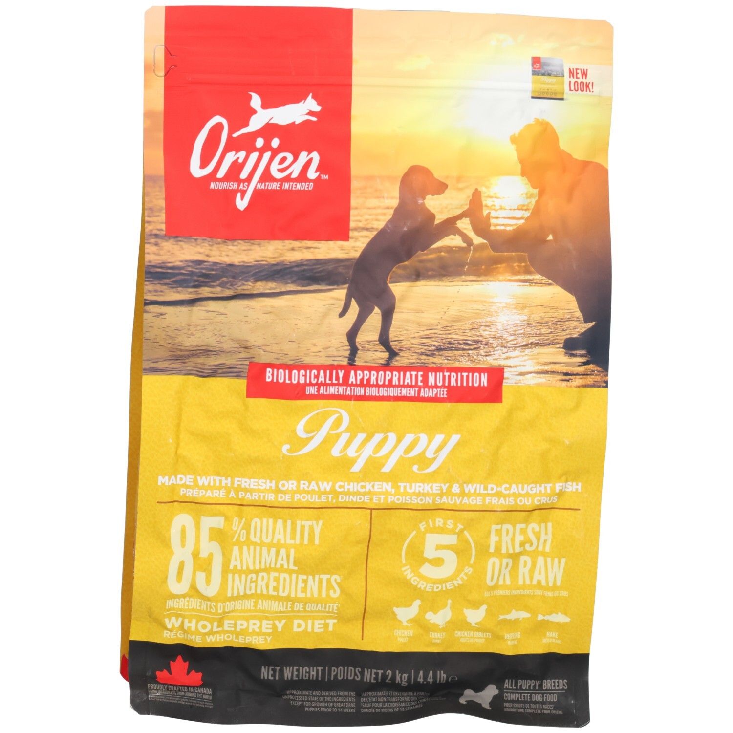 Sac de nourriture pour chiot Orijen, 2kg. Face avant avec image d'un homme et d'un chiot sur la plage.