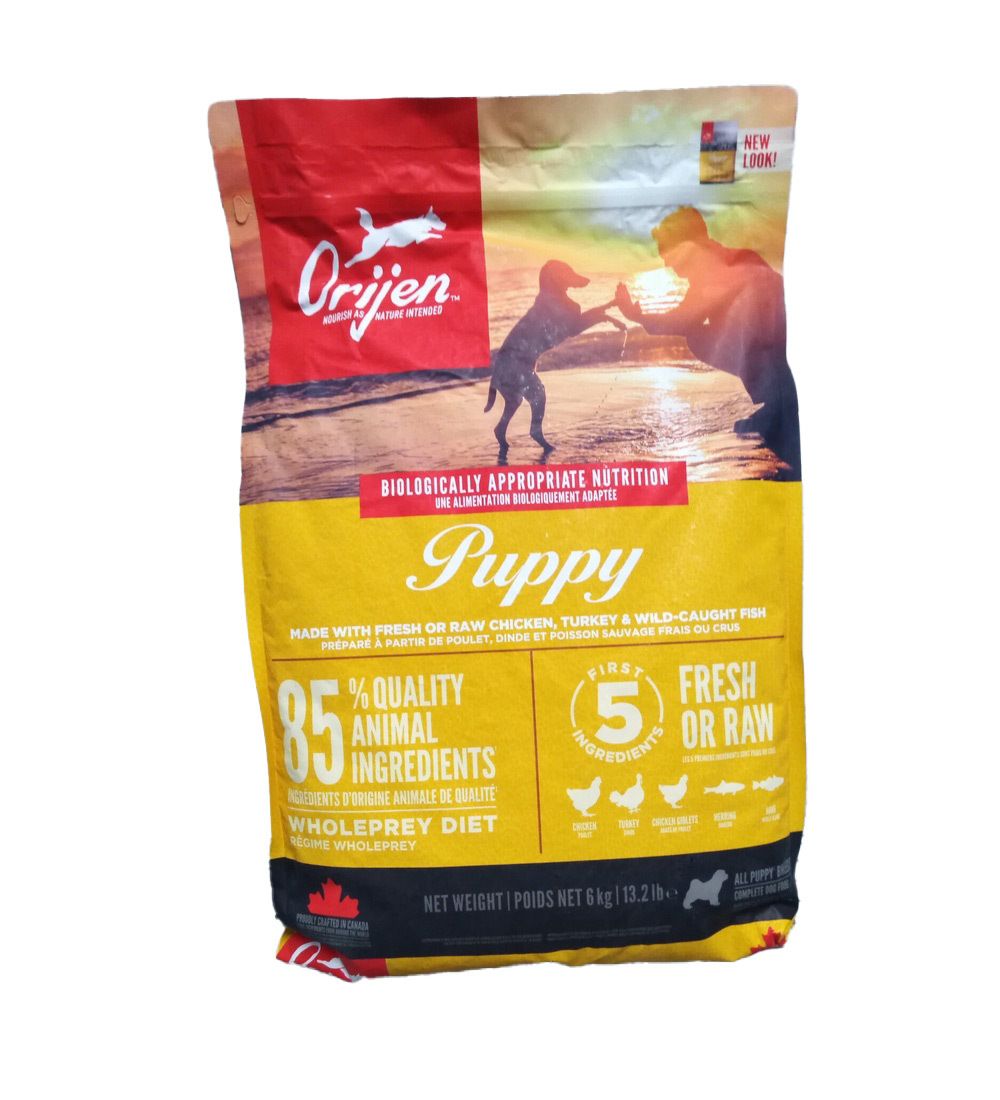 Sac de nourriture pour chiots Orijen 6 kg. Sac rouge et jaune avec logo, illustration de chiot et texte : 85 % d'ingrédients d'origine animale.