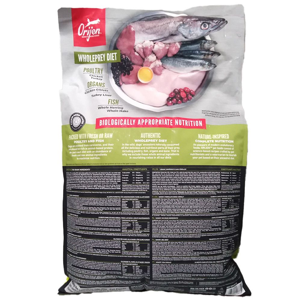 Arrière d'un paquet de nourriture pour chien Orijen Wholeprey Diet, avec une image d'ingrédients crus tels que poisson et viande.