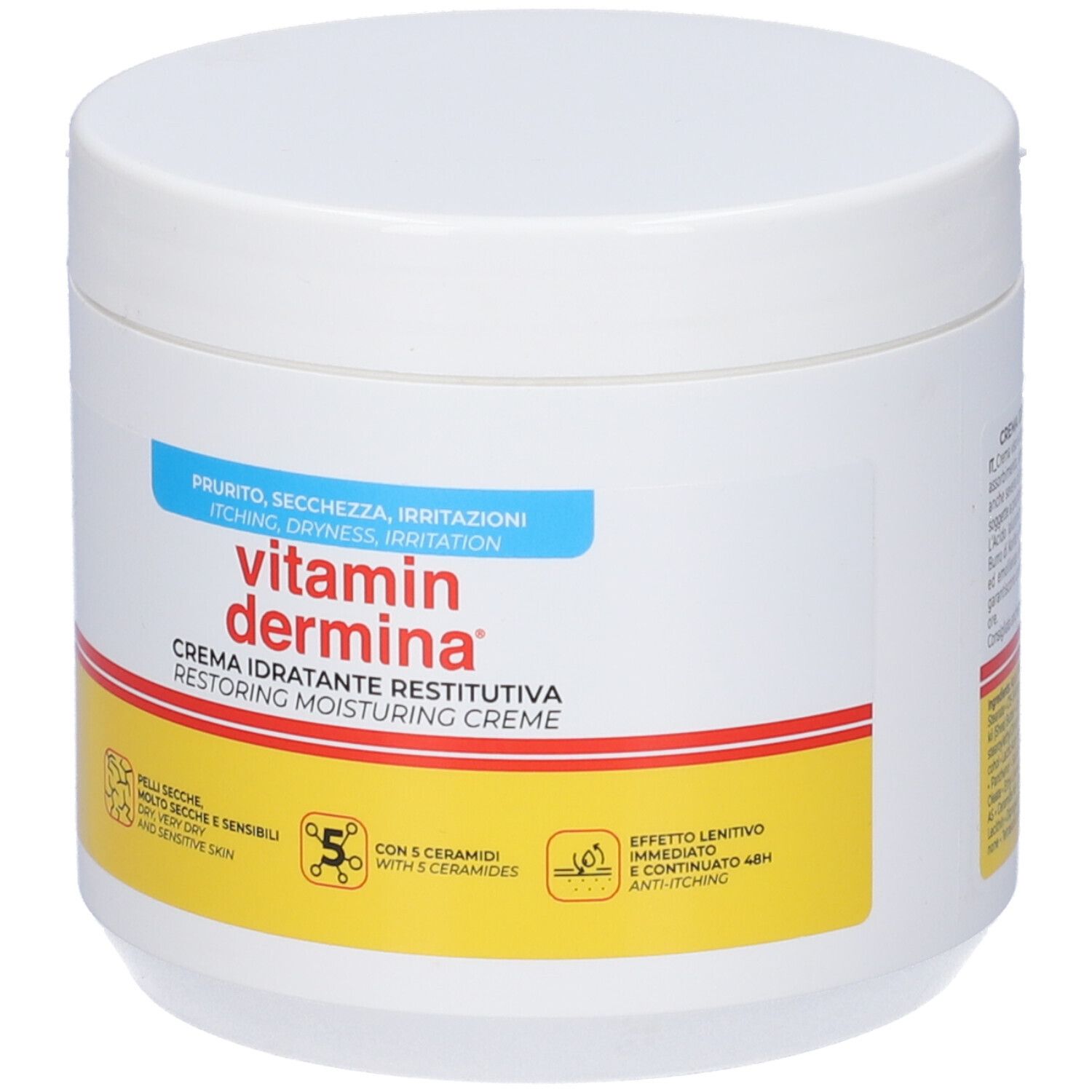 Pot blanc avec texte rouge et jaune. Inscription : Vitamin Dermina, Crème idratante restitutiva. Pour peaux sèches et sensibles.