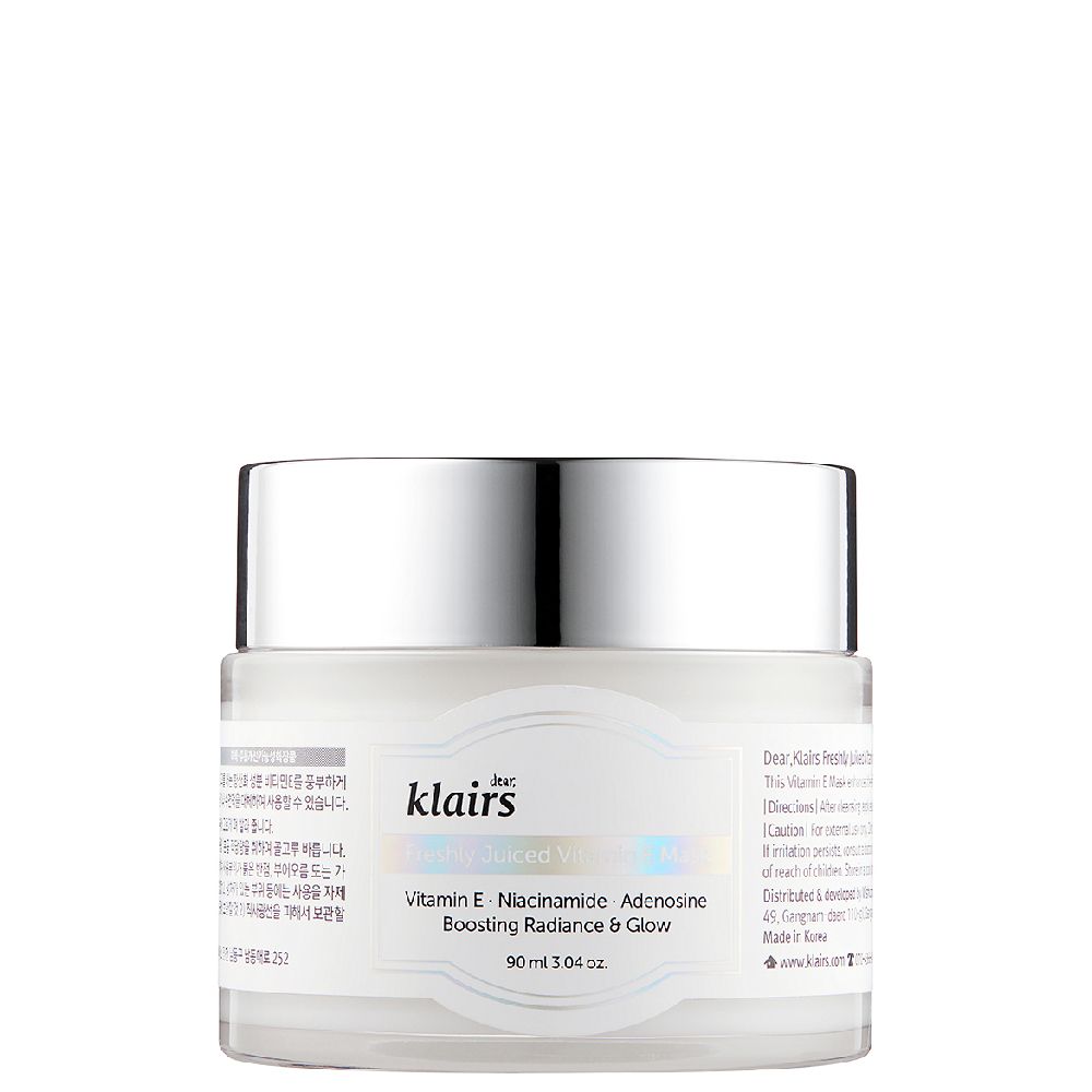 Un pot du masque à la vitamine E fraîchement pressée avec un couvercle argenté, isolé sur fond blanc.