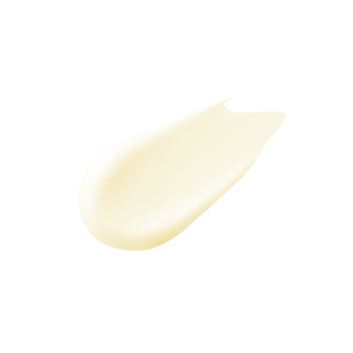 Crème étalée sur fond blanc. Couleur jaunâtre. Forme : en forme de goutte.