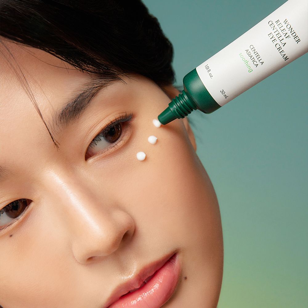 Une personne applique de la crème contour des yeux, appliquée sur la peau à partir d'un tube.