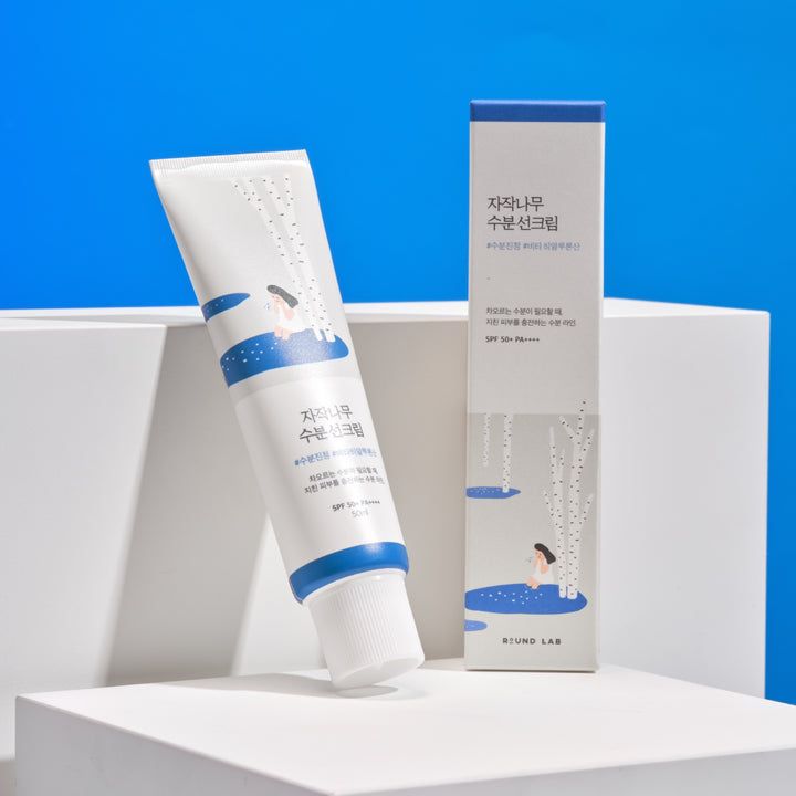 Tube et boîte du produit solaire avec motif de bouleau.