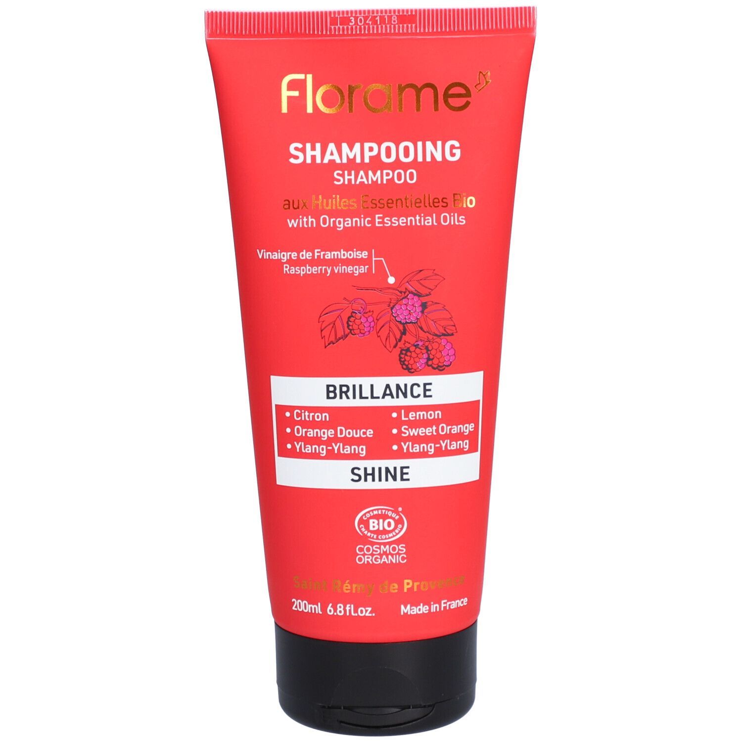 Tube rouge Florame Shampoo. Texte: "Shampooing", "Brillance", "Huiles Essentielles Bio".